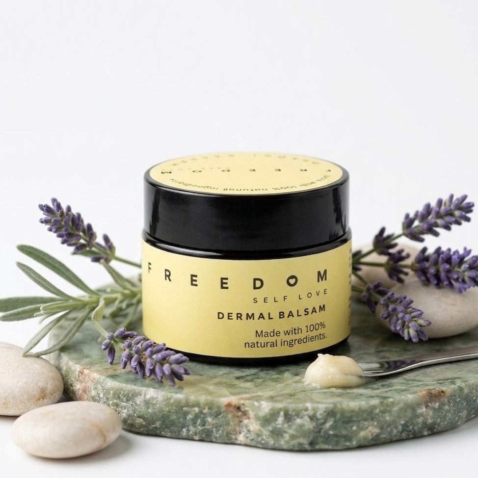 Jar of 'Freedom' dermal balsam with lavender and stones on a white background