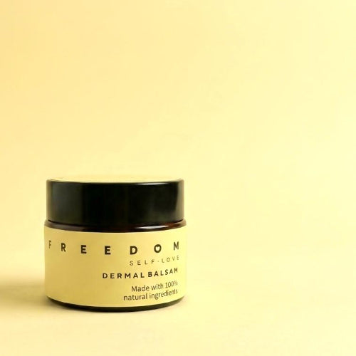 Jar of 'Freedom Self-Love Dermal Balsam' on a light yellow background