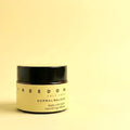 Jar of 'Freedom Self-Love Dermal Balsam' on a light yellow background